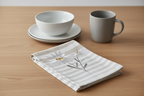 Folded tea towel on oak surface