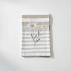 Folded tea towel on white surface