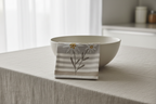 Tea towel draped over ceramic bowl