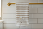 Tea towel hanging on brass rail